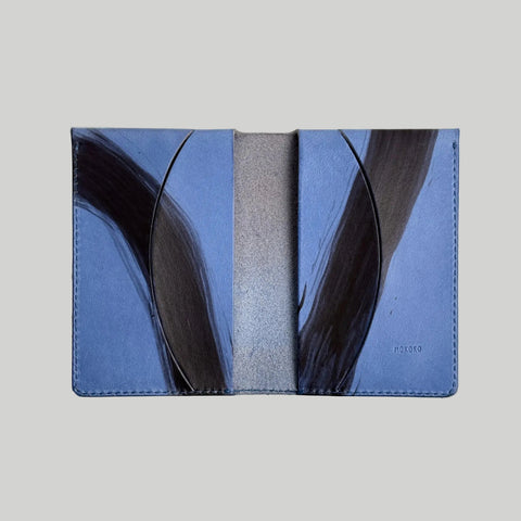 Blue and gray wallet with abstract design on a light beige background