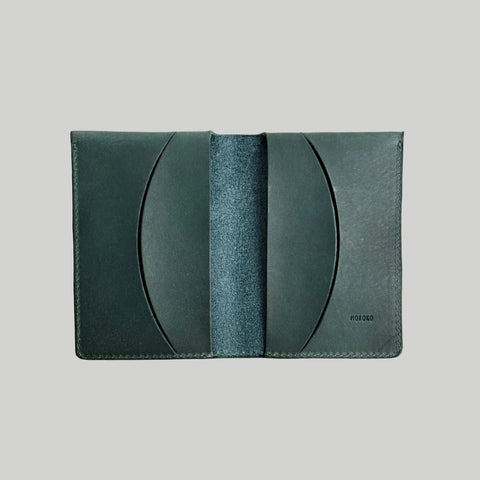 Green leather wallet on a light gray background