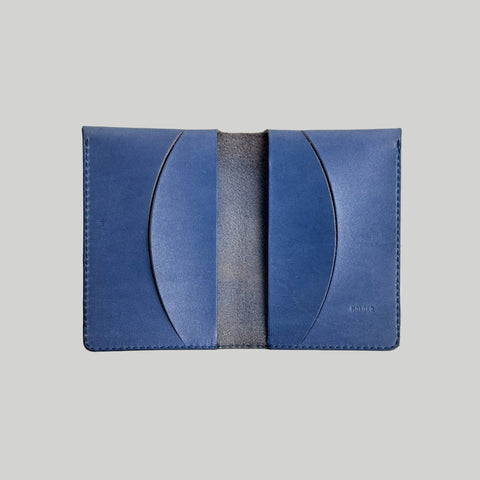 Blue leather cardholder on a light gray background