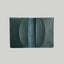 Green leather wallet on a light gray background