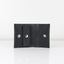 A closed black leather wallet with snap fastener closure and a coin compartment.
